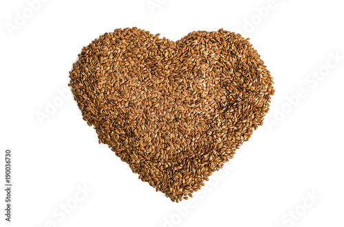 Diet of a healthy diet. Raw linen seeds flaxseed heart formed on a white background © Sergey