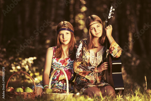 Two young fashion girls with fruit baskets in summer forest © Wrangler