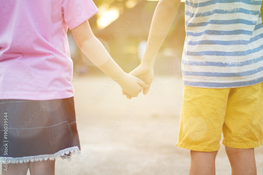 Couple of Little boy and girl stand and holding hand together love family concept,selective focus. Couple of Little boy and girl stand and holding hand together love family concept,selective focus.