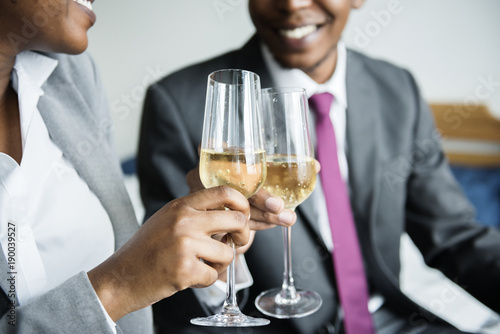 A couple celebrating with a bottle of champagne