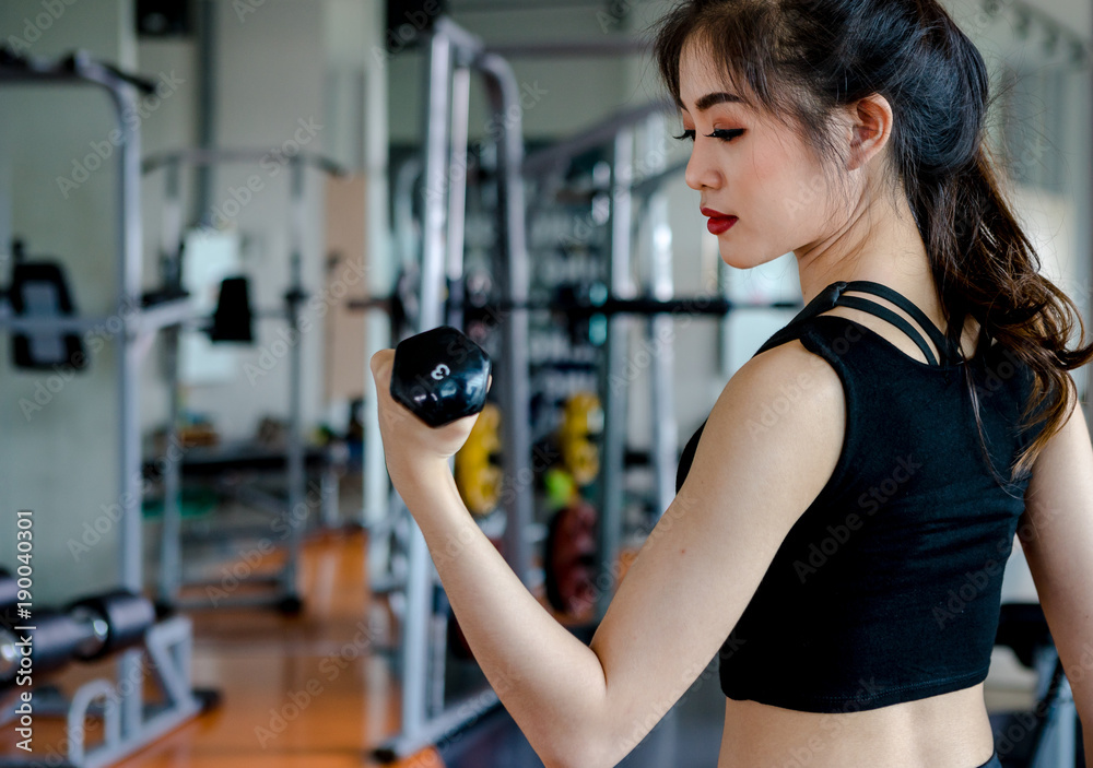 Asian woman exercising in the gym, Young woman workout in fitness for her healthy and office girl lifestyle. Asian woman exercising in the gym, Young woman workout in fitness for her healthy and office girl lifestyle.