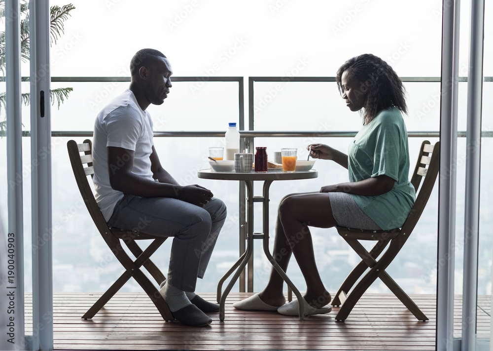 Couple having breakfast together at the balcony Couple having breakfast together at the balcony