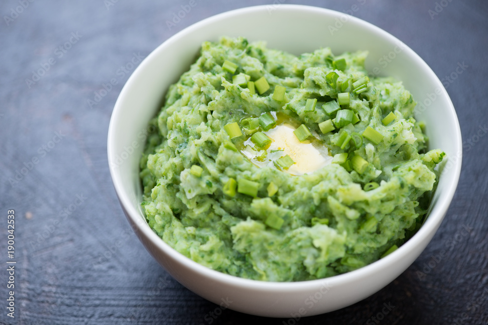 White bowl with Irish colcannon or mashed potato with kale, leek and green onion, traditional meal for Saint Patrick’s Day, close-up White bowl with Irish colcannon or mashed potato with kale, leek and green onion, traditional meal for Saint Patrick’s Day, close-up