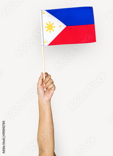 Hand holding philippine flag