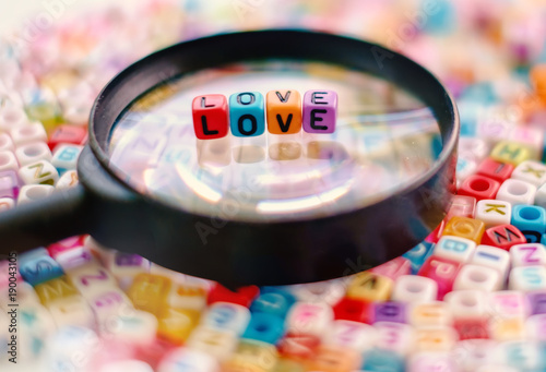 Word LOVE on the magnifying...