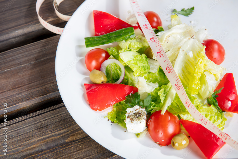 vegetable salad on plate and centimeter for measuring body vegetable salad on plate and centimeter for measuring body