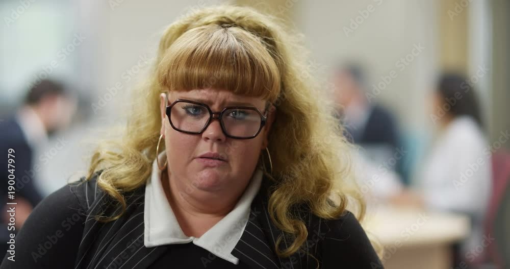 4K Portrait overweight businesswoman trying not to cry with her bottom lip wobbling. Funny office concept, workplace problems. Slow motion. 4K Portrait overweight businesswoman trying not to cry with her bottom lip wobbling. Funny office concept, workplace problems. Slow motion.