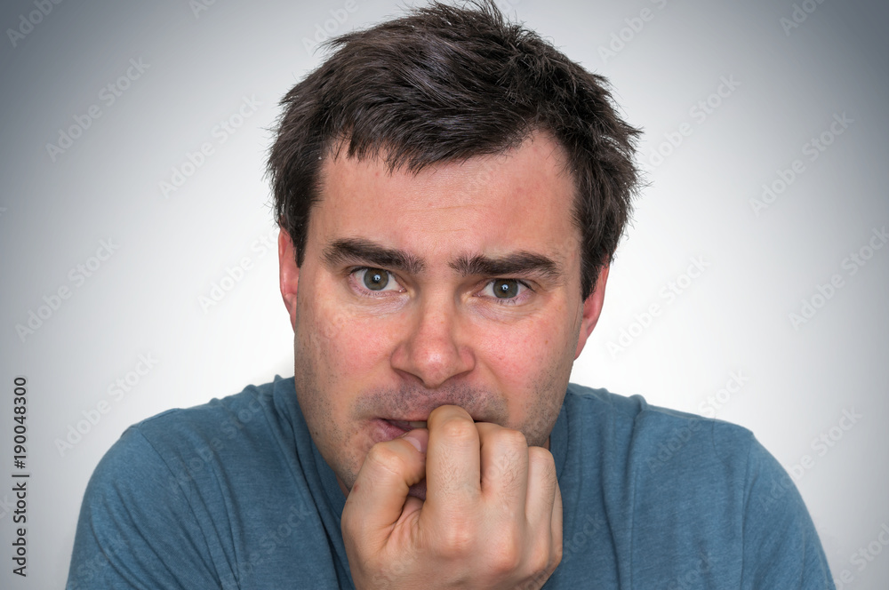 Nervous man biting his nails - nervous breakdown Nervous man biting his nails - nervous breakdown