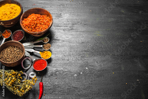Spices and herbs with measuring spoons.