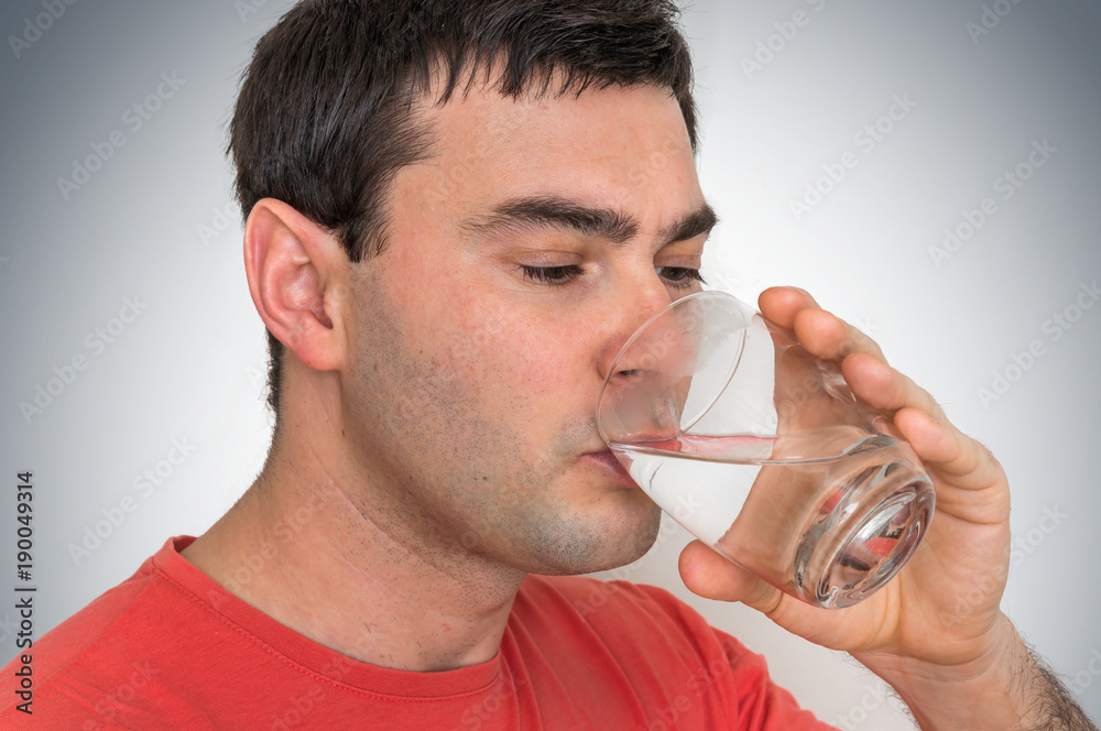 Young man drinking fresh water Young man drinking fresh water