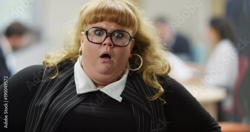 4K Portrait funny businesswoman looking at camera, reacting with exaggerated shock. Slow motion.