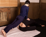 beautiful girl doing thai back massage in spa saloon