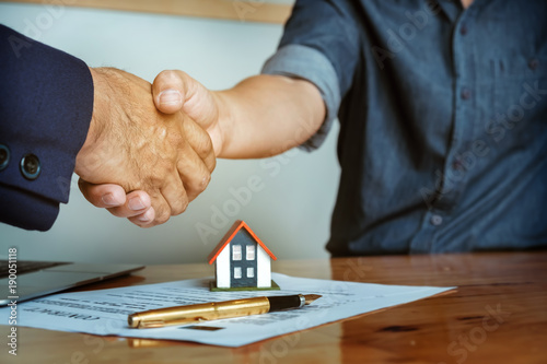 Customers agree to buy a house with a real estate agent. Signing contract. Agreement concept.