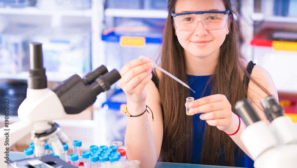 A teenage girl in a school laboratory in chemistry and biology classes A teenage girl in a school laboratory in chemistry and biology classes