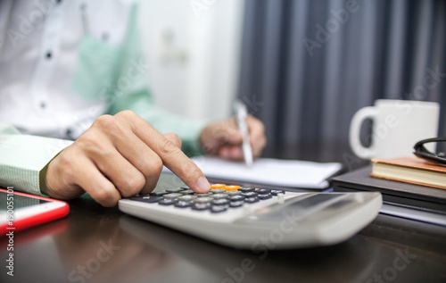 Businessman using calculator financial business calculation