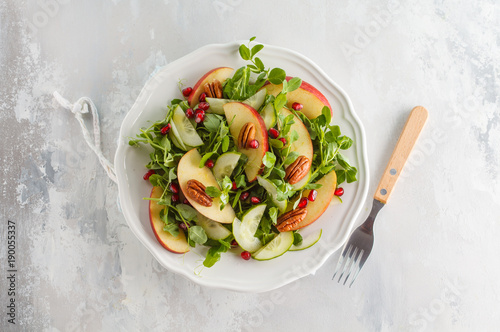 Light green apple pecan pomegranate salad. Vegan Healthy Food Concept. Top view, copy space