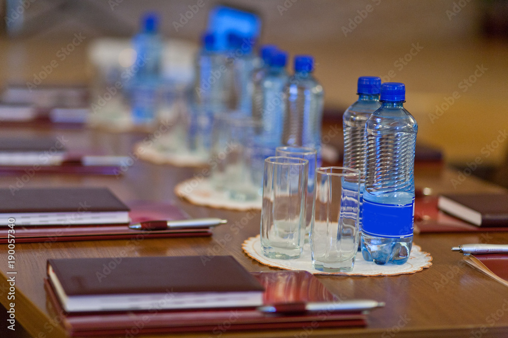 table setting for meetings. mineral water, folder, pen. table setting for meetings. mineral water, folder, pen.