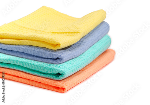 Set of folded multicolored waffle towels closeup with selective focus