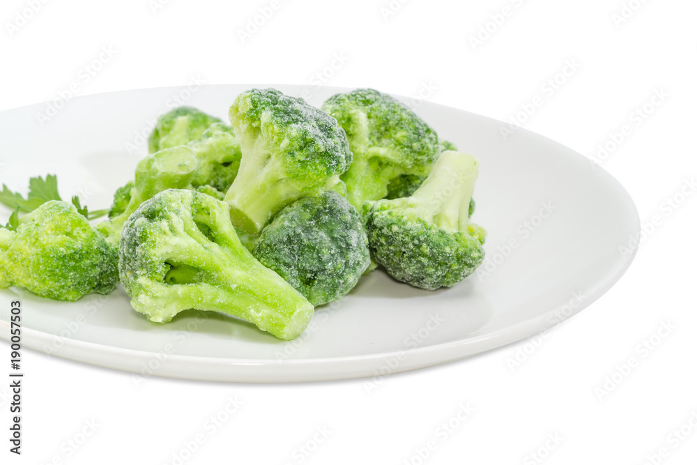 Frozen broccoli on dish closeup on a white background Frozen broccoli on dish closeup on a white background