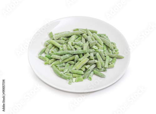 Frozen green beans on dish on a white background