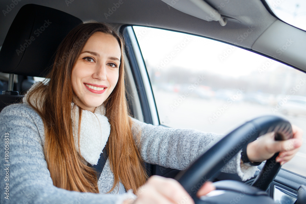 Young woman drive a car in winter
