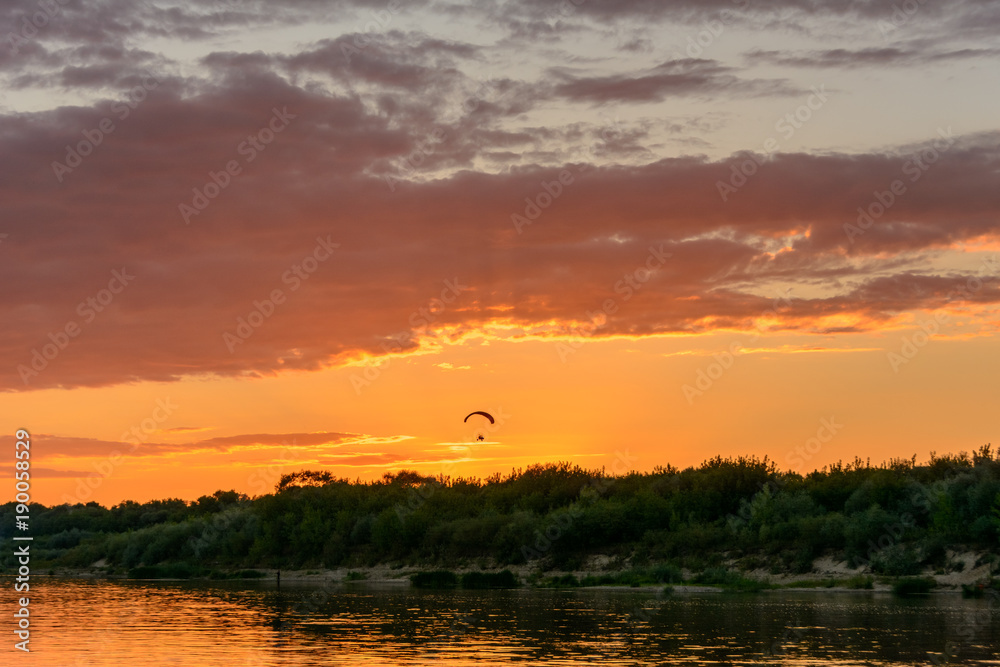 Paragliding in the sky at sunset.