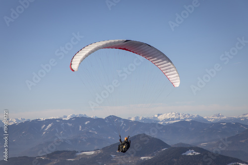 paragliding from mountain schoeckl in styria, austria. in the background mountain range hochschwab photo