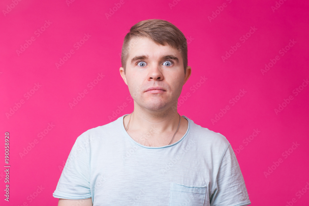 Surprised man with bulging eyes on pink background Surprised man with bulging eyes on pink background