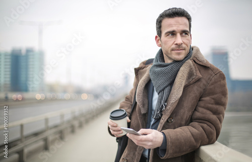 Handsome man waiting for someone in the street