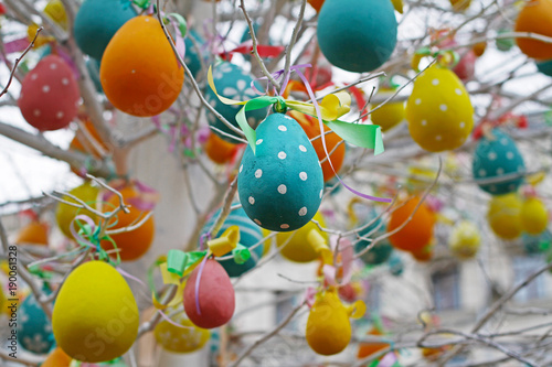 Colorful decorated easter eggs hanging on tree branches