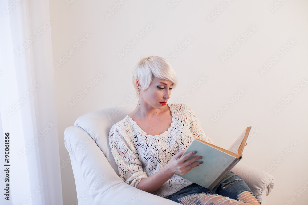 blonde girl reading a book is preparing blonde girl reading a book is preparing