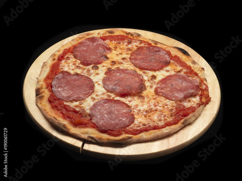 salami pizza on a wood dish