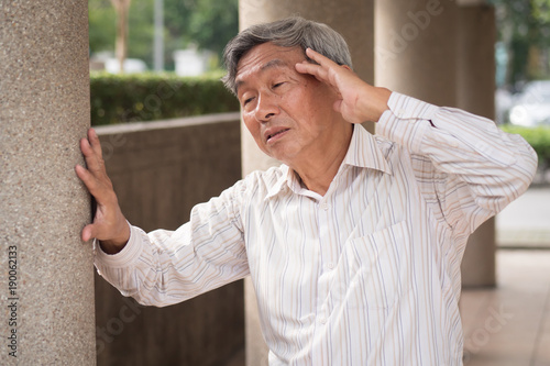 stressed hopeless senior old man suffering from chronic headache pain, migraine, stress, hangover photo