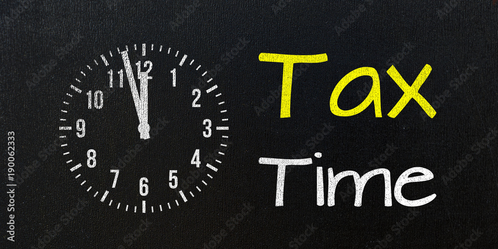 tax time, message on blackboard with clock tax time, message on blackboard with clock