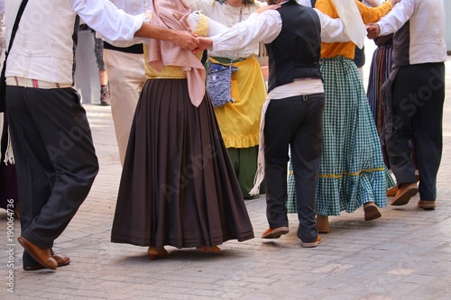 Dancers in traditional dresses at a public Canarian festival photo