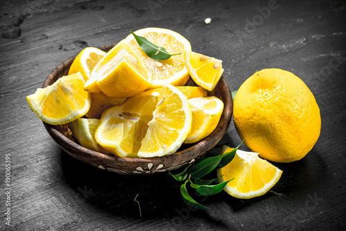 Sliced slices of lemons in a bowl. photo