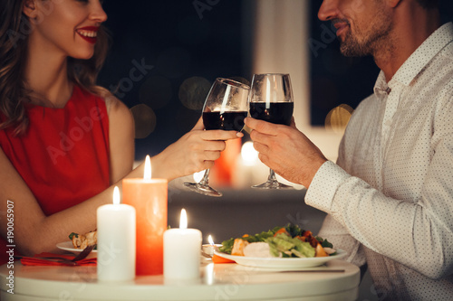 Fotografie, Obraz Cropped photo of lovers having romantic dinner at home