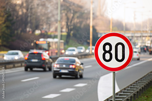 Traffic sign showing speed limit on a highway full of cars photo