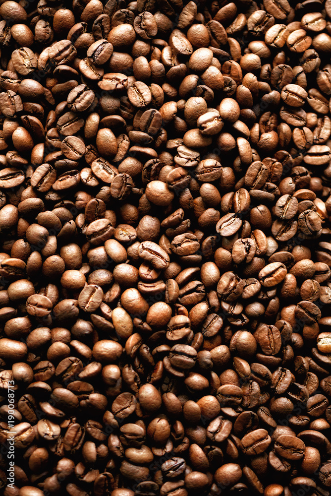 Naklejka premium Roasted coffee beans backgound, copy space, top view. Cappuccino, dark espresso, aroma black caffeine drink, ingredient for coffee beverage.