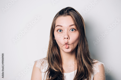Beautiful brunette woman, making crazy funny grimace.