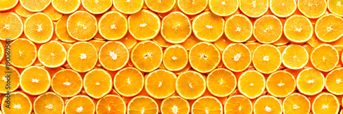 Fresh sliced orange fruit texture. Macro, top view, copy space, banner. Food frame. Juicy oranges background