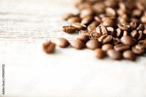 Coffee beans on light wooden background with copyspace for text. Coffee background, food frame, texture concept. Banner photo
