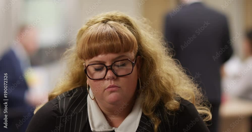 4K Overweight businesswoman falling asleep during very boring conference call in the office