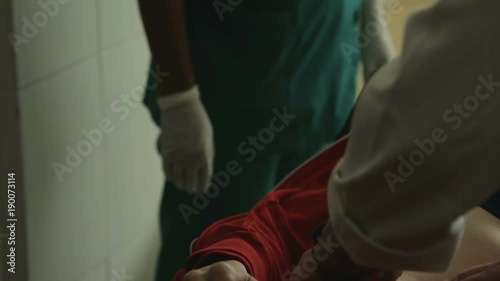 Doctor palpating abdomen of injured woman in hospital, complaining for pain