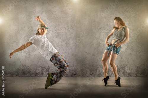 Fototapeta Naklejka Na Ścianę i Meble -  Hip Hop dancer in dynamic action jump on the grunge grey backgro