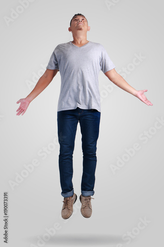 Levitation. Young Man Walking Jumping on Air photo