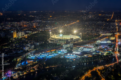 Melbourne Cricket Ground and Yarra Park tennis stadium illuminated at sunset. © nilsversemann
