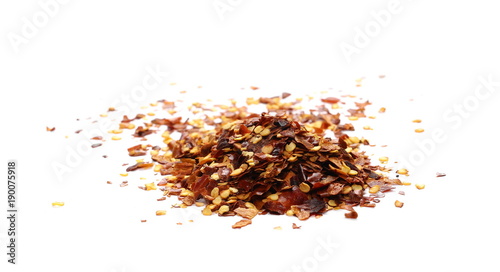 Crushed dry, spicy pepper, chili flakes and seeds isolated on white background