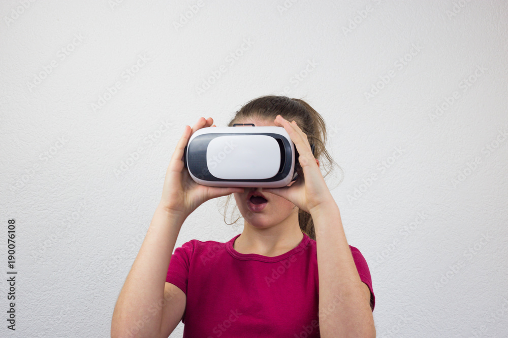 Teenager with virtual reality glasses on the head, enjoying watching, amazing technology, white background, studio Teenager with virtual reality glasses on the head, enjoying watching, amazing technology, white background, studio