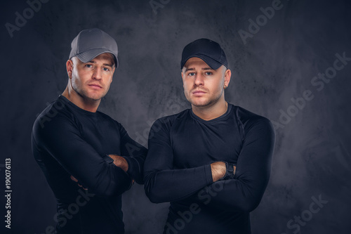 Portrait of two handsome young male dressed in a black sportswea photo